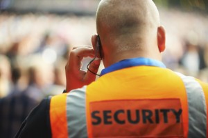 Rear view of a security guard listening to his headset